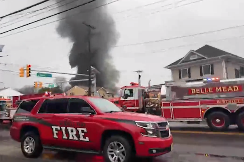 Emergency responders assist at the scene of a mattress fire in New Brunswick on Wednesday.
