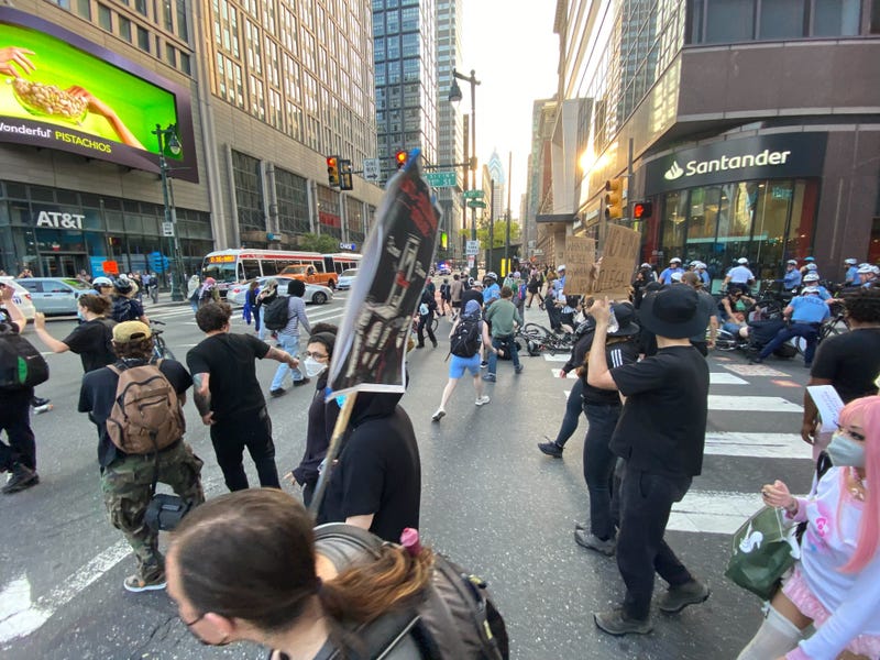 Protestors march in a rally against ICE raids earlier this week that ended with 15 people arrested.