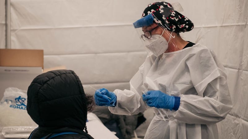 A medical worker administers a COVID-19 test at a new testing site inside the Times Square subway station on December 27, 2021 in New York City.