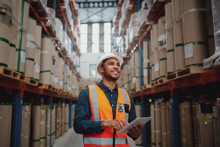 Worker in protective equipment survey warehouse