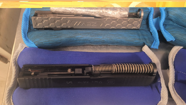 Concealed gun parts found in box of ankle, wrist weights in man's luggage at Newark Airport