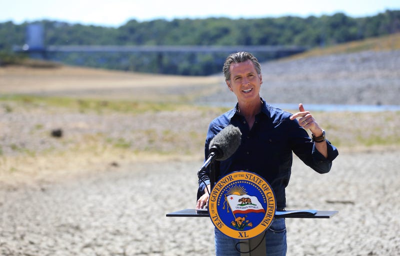 In this April 21, 2021, file photo California Gov. Gavin Newsom speaks at a news conference in the parched basin of Lake Mendocino in Ukiah, Calif., where he announced he would proclaim a drought emergency for Mendocino and Sonoma counties. On Thursday July 8, 2021, Newsom asked people to voluntarily reduce their water use by 15% in the middle of the drought. He also added nine more counties to the state's emergency proclamation. (Kent Porter/The Press Democrat via AP, File)