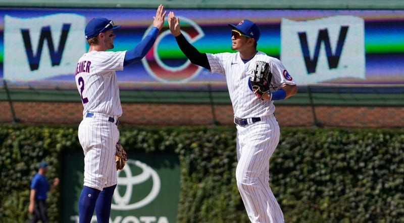 Cubs second baseman Nico Hoerner, left, and outfielder Seiya Suzuki celebrate after a win.