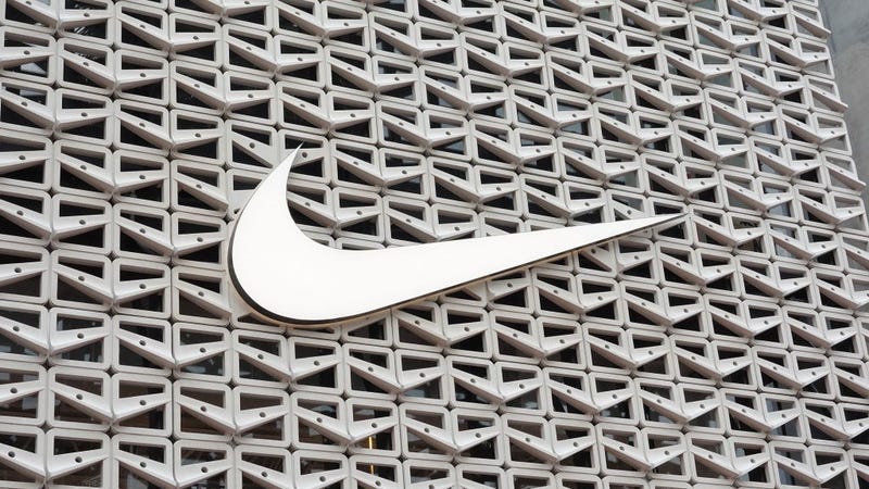 The Nike logo hangs above the entrance to the Nike store on December 21, 2021 in Miami Beach, Florida. 