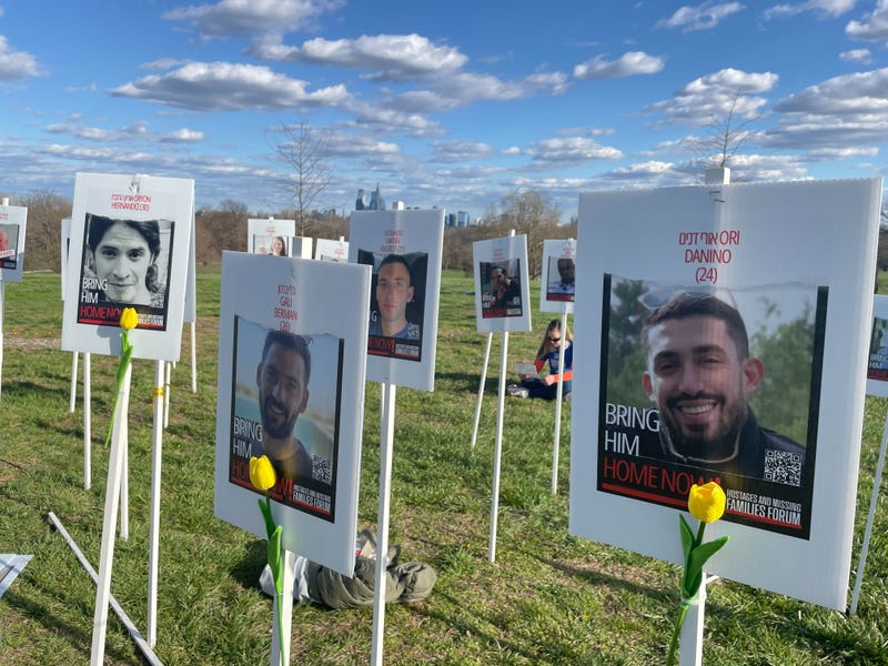 Photos of those killed or still held hostage by Hamas with yellow flowers planted near the Belmont Plateau in Fairmount Park.