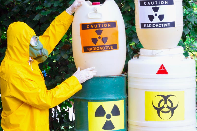 Chemist with the gas mask and the protective suit the disposal of radio active waste,photography