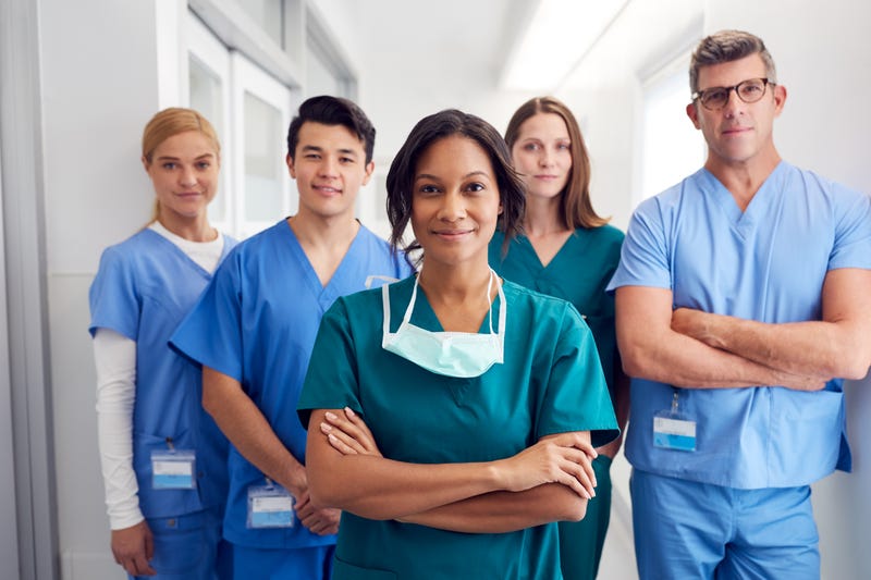 A group of nurses in a hospital corridor