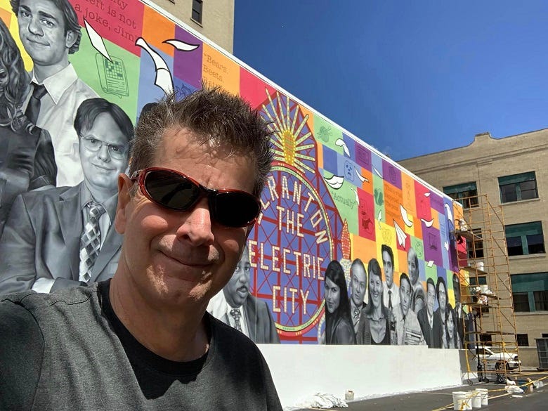 Rocky in front of "The Office" mural