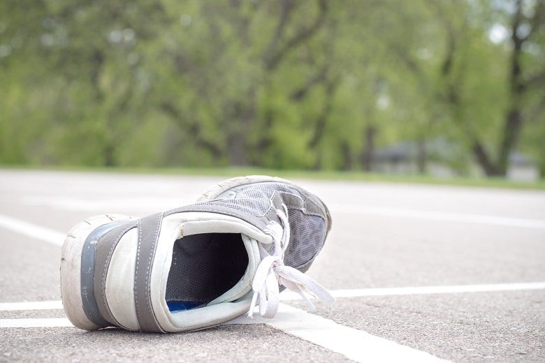one shoe in road
