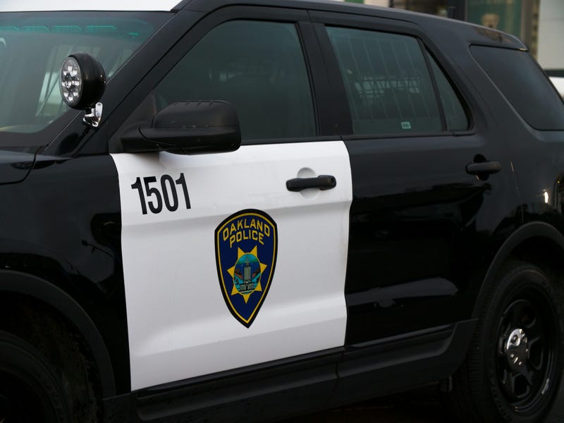 An Oakland Police Department car with logo emblazoned on the vehicle