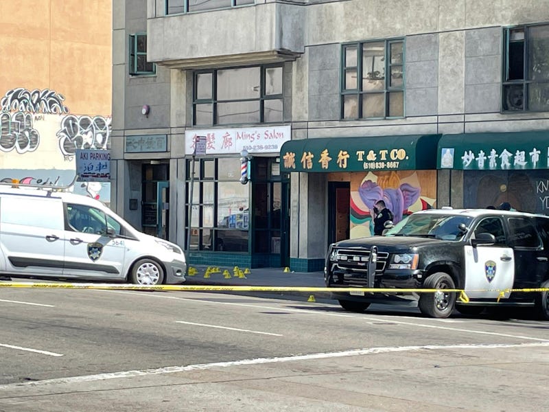 Police vehicles outside the scene of a shooting in Oakland's Chinatown District on Monday afternoon.
