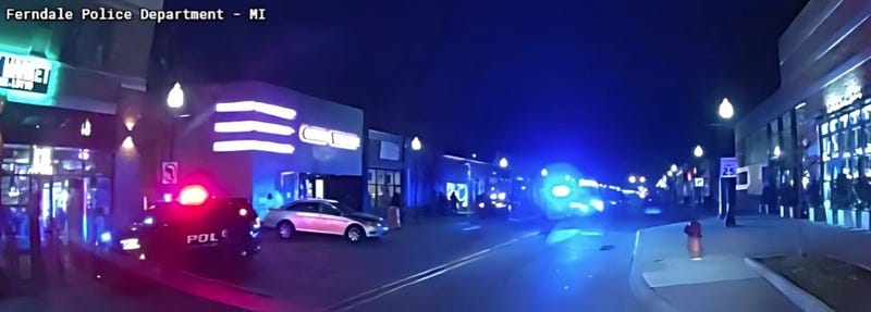 Dark alley lit up by police lights