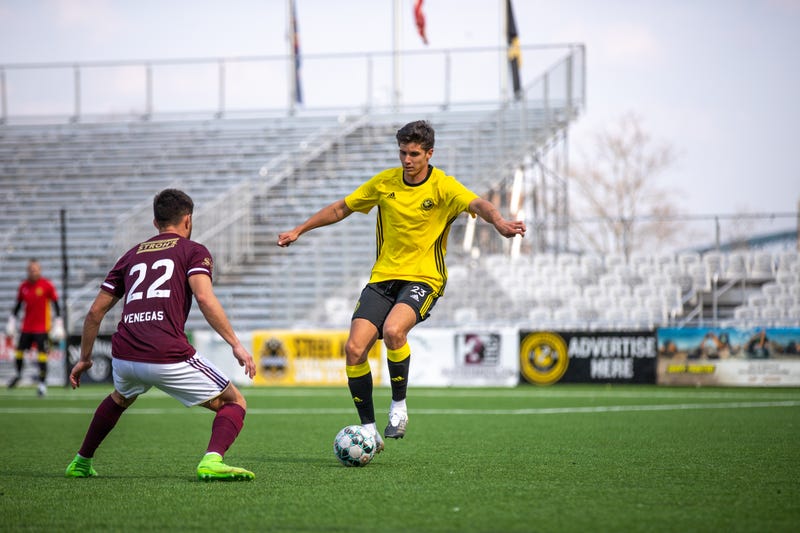 Riverhounds player dribbling