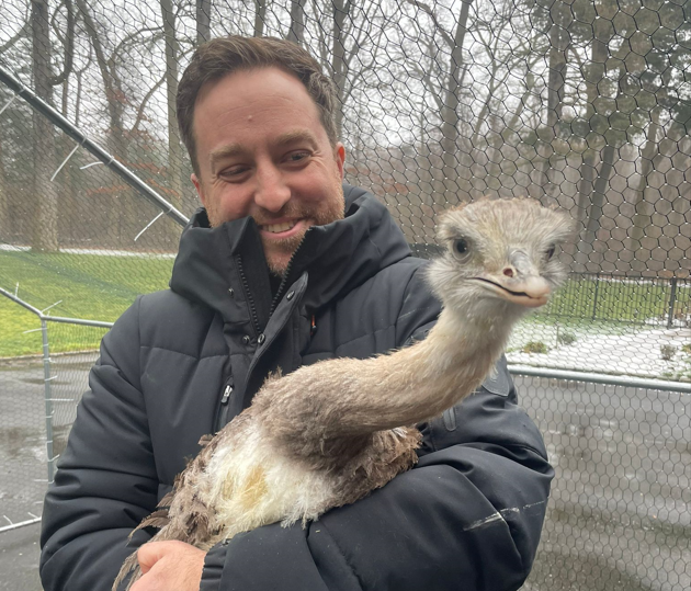 John Di Leonardo holds the South American ostrich seized from the home