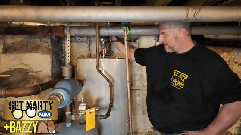 Plumber Robert Arms fills the tank he's installing for Lee.