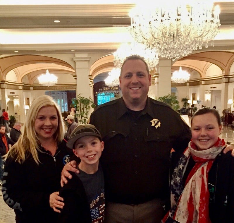 Metro Police officer Phil Closi poses with his wife and two kids