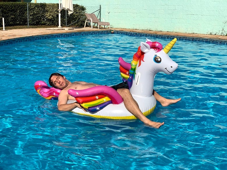 Guy floating in pool