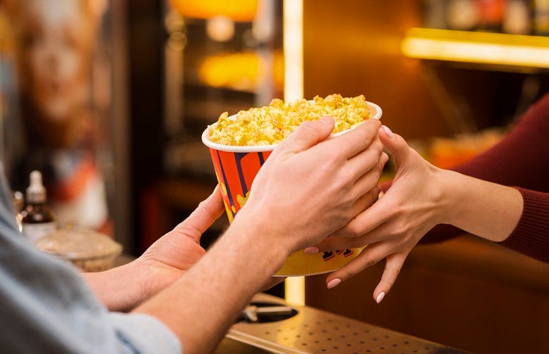 Getting popcorn at a movie theatre