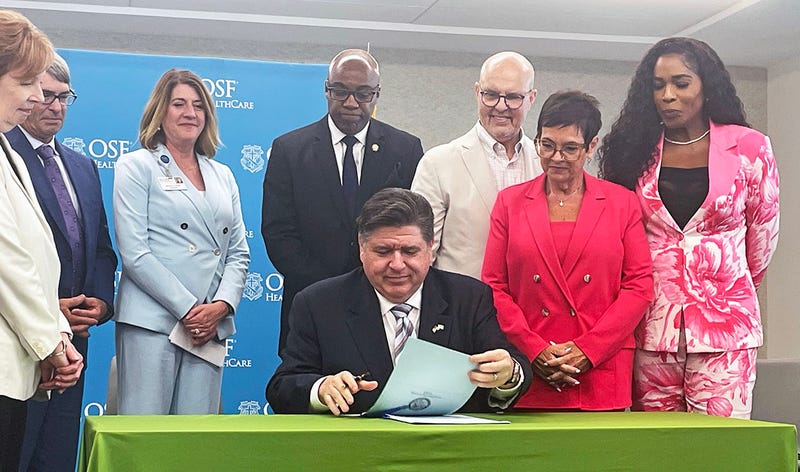 Gov. JB Pritzker signs two bills related to health care costs while at a hospital in Peoria, including a bill that puts more controls on pharmacy benefit managers.