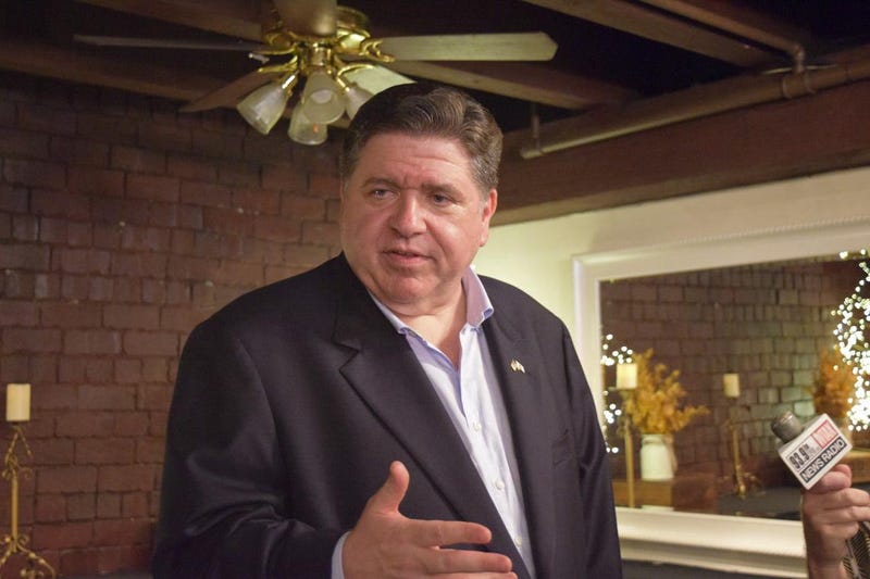 Gov. JB Pritzker speaks with reporters after his campaign announcement in Springfield on Thursday.