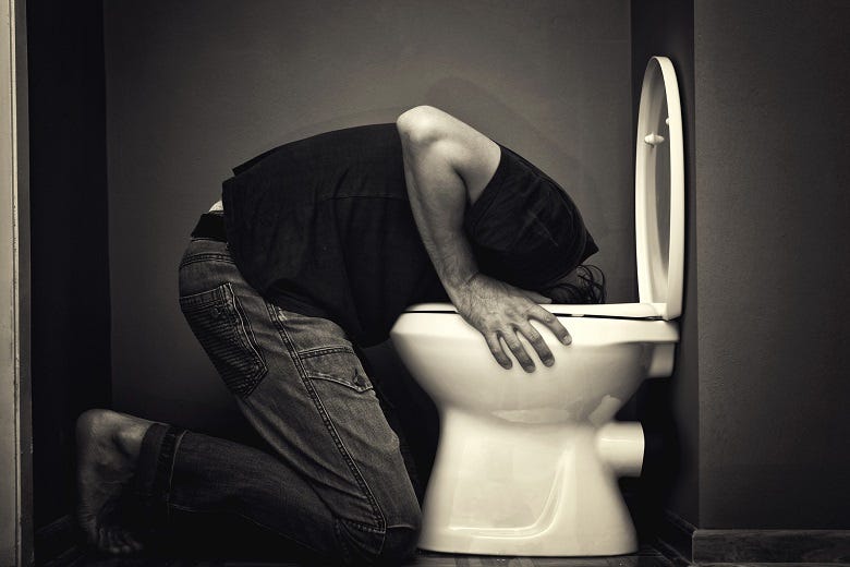 Man throwing up in toilet
