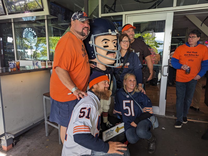 Matt Butkus (far left), poses with a bobblehead of his late father Dick Butkus at a tailgate honoring the legendary linebacker
