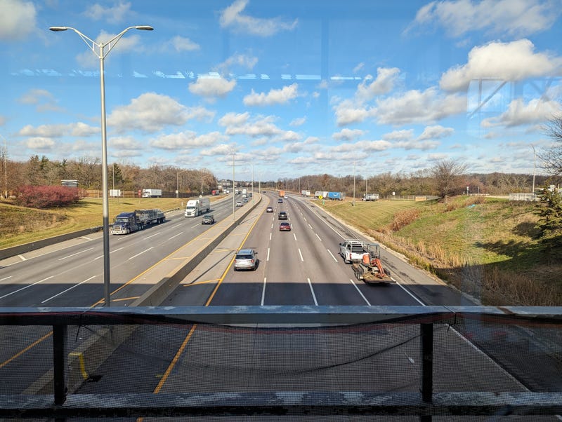 Cars drive underneath the Lake Forest Oasis on Wednesday. Illinois Tollway officials said Wednesday was expected to be the busiest day on Illinois toll roads, with some 1.8 million cars and trucks on the road.