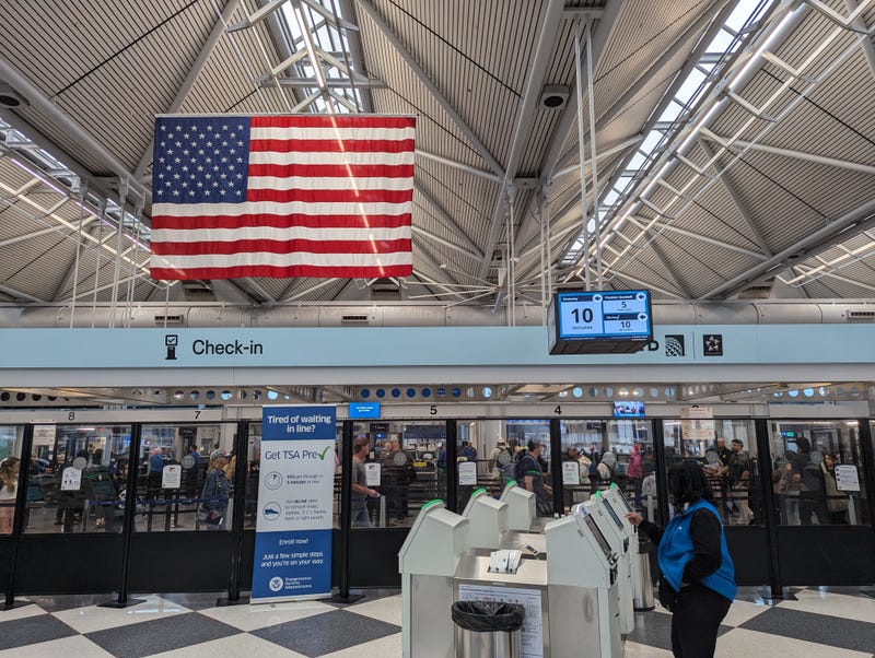 An American flag hangs over one of the check-in areas inside O'Hare Airport on July 3, 2024. City officials said the airlines are expecting Wednesday to be the busiest travel day of the holiday.