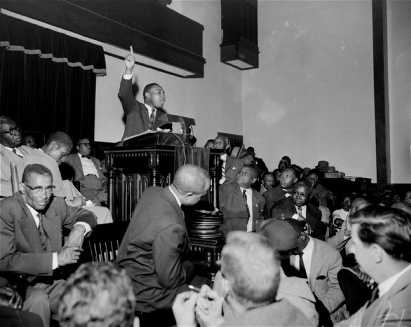 The Rev. Martin Luther King Jr. points skyward as he speaks at a mass meeting at Holt Street Baptist Church in Montgomery, Ala., during the Montgomery Bus Boycott.