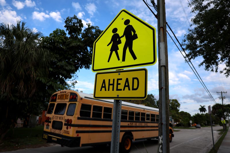 A sign indicates where pedestrians can legally cross