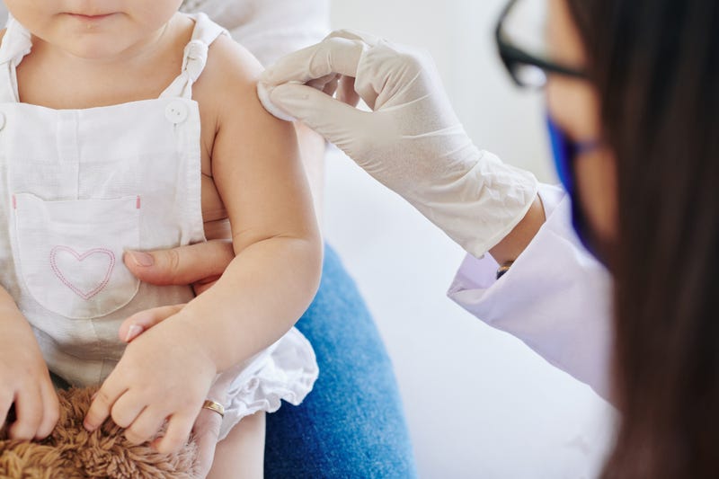 A young girl receives her coronavirus vaccination