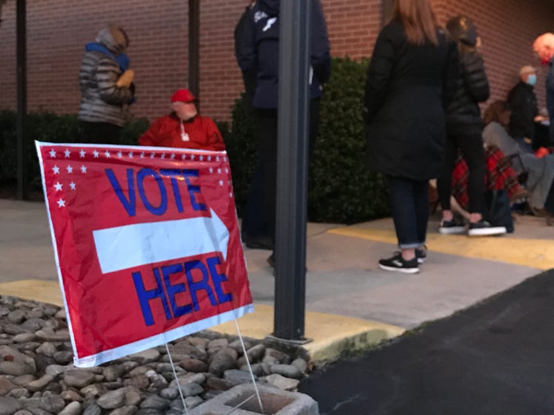 A voting sign directs voters to precinct entrance off Pelham Road