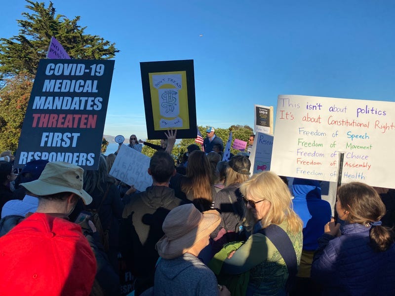 Protesters hold signs in a demonstration against COVID-19 vaccine mandates at the Golden Gate Bridge.