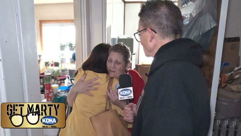 Bea Gelman hugs Kristen after presenting her with "Bruce's Wish"
