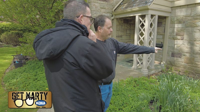 Bud Norton shows Marty Griffin what's causing the water leak in his basement.