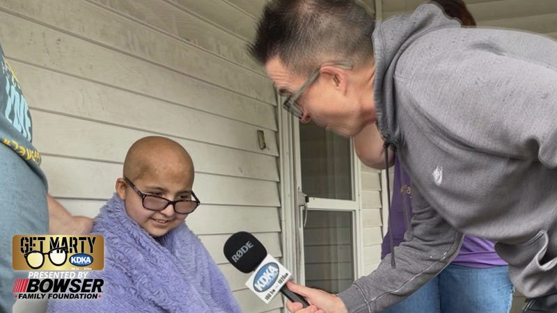 Marty Griffin talks to Jaycee Amick, 12, about her swimming pool