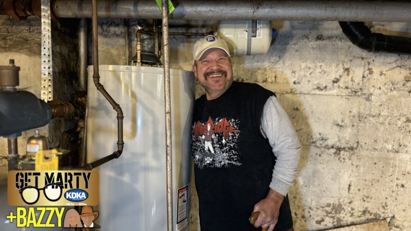 Lee hugs the water heater that was just installed by Greater Pittsburgh Plumbing, Heating & Cooling.