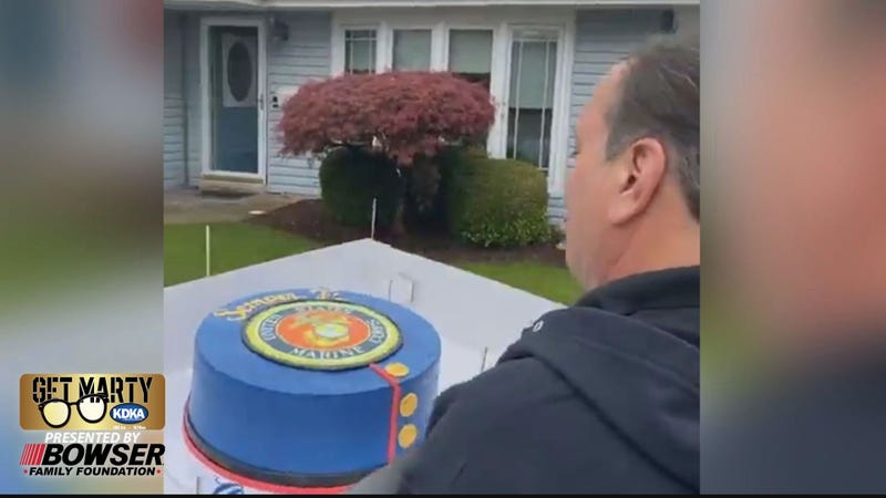 Oakmont Bakery owner Marc Serrao delivers a special cake to retired U.S. Marine Hal Shaffer.