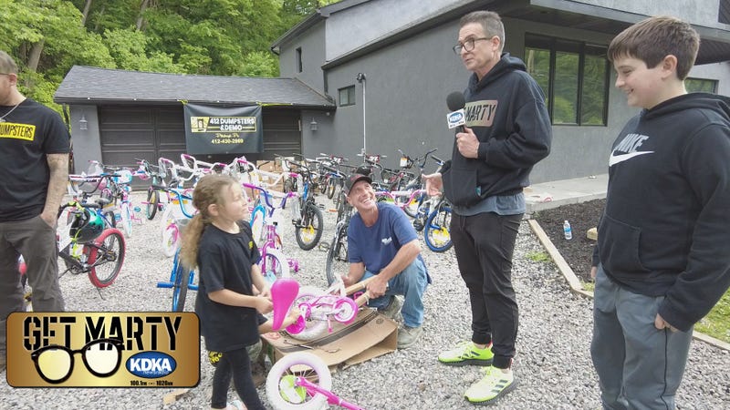 Marty and Vince Griffin talk to the Gunde family about their bike drive for kids.