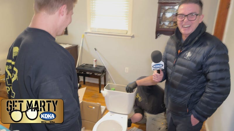 Crews from Greater Pittsburgh Plumbing put together Gloria's new toilet.
