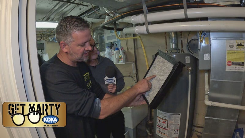 Brent Worth with Greater Pittsburgh Plumbing, Heating & Cooling shows Marty his dirty filters.