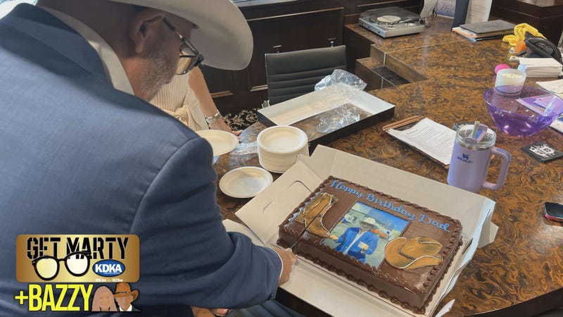Richard Bazzy cuts into a custom cake from Oakmont Bakery.