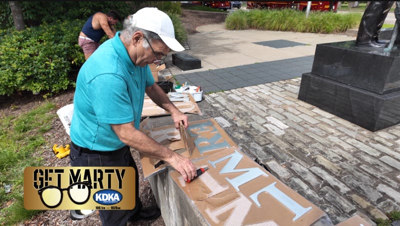 John Dioguardi and his Rome Monument team install letters at the memorial.