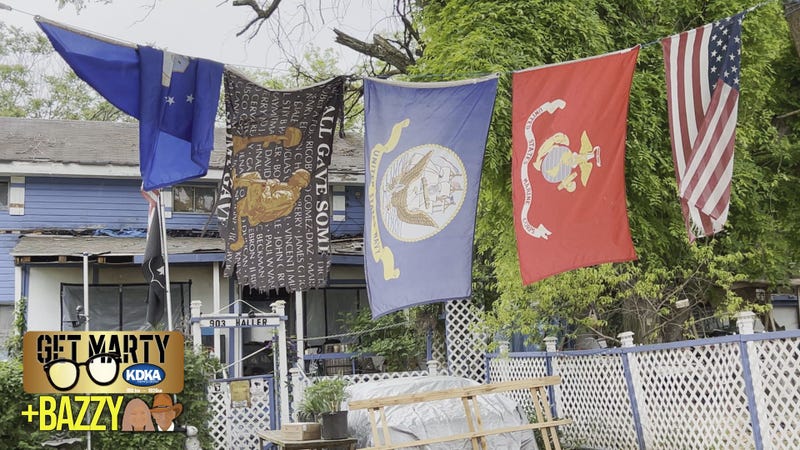 Flags flying over Chuck Geiger's home show his service in the U.S. Army veteran and other family serving in almost every other branch.