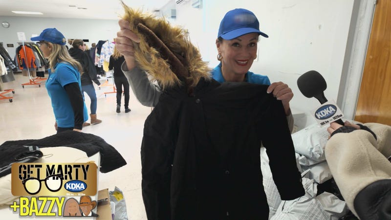 Terri Dakan shows Arianna Bazzy the new coats she donated to the West Hills Food Pantry.