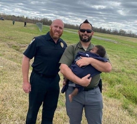 Two police with recovered baby