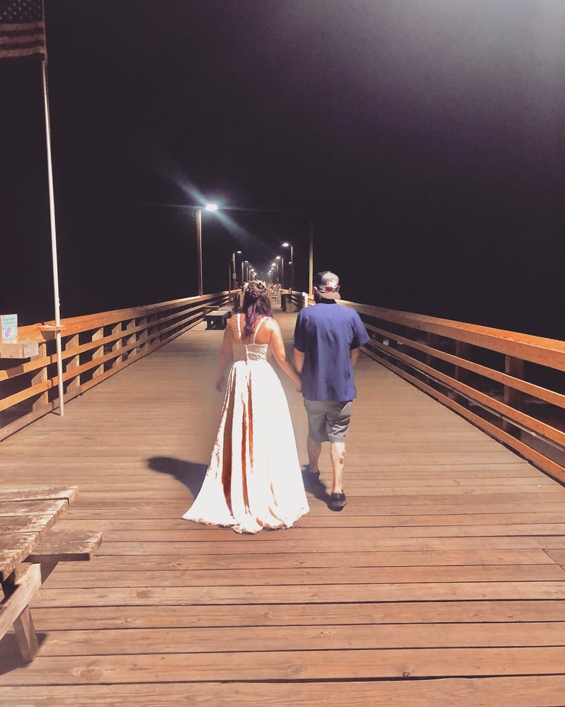 Alanna and Eric walking the Surf City fishing pier after the wedding