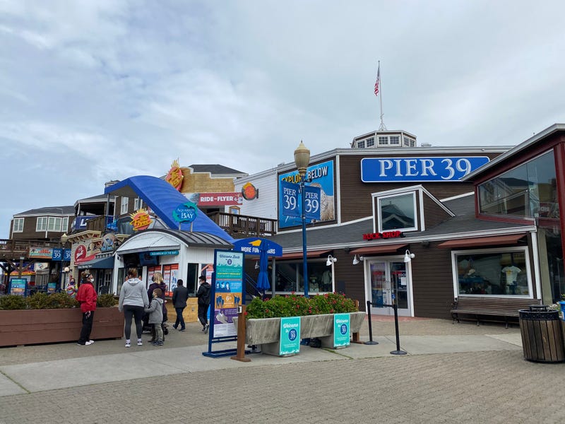 The normally buzzing shops at San Francisco's Pier 39 are low key these days, but tourists look to be returning in small numbers.