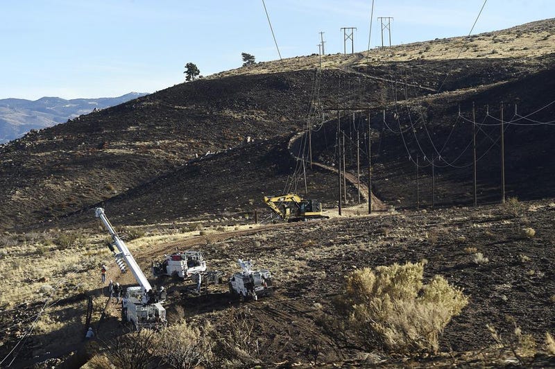 NV Energy repairs power lines are damaged in the area of origin of the Pinehaven Fire in Reno, Nev., on Nov. 19, 2020