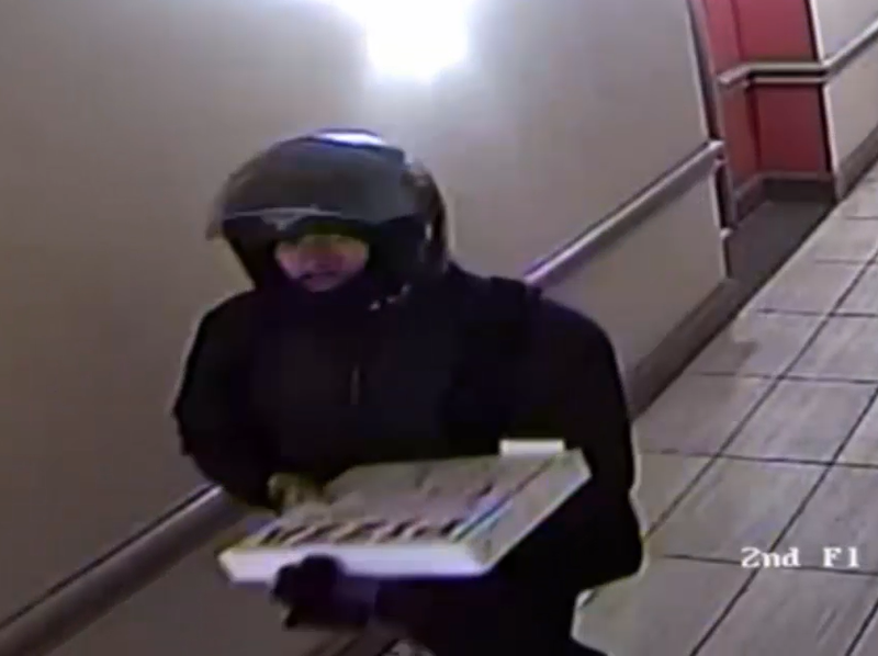 Video shows the suspect wearing a helmet and carrying a pizza around the time of the theft on Feb. 14, 2025\